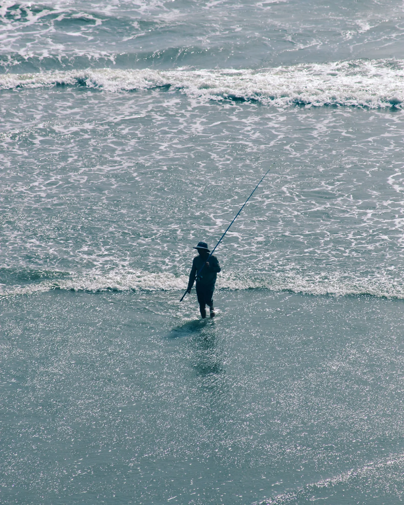 Inshore, the rule shrinks to walking scale: find the seam between stirred-up water and clean, and fish the clean side of it.